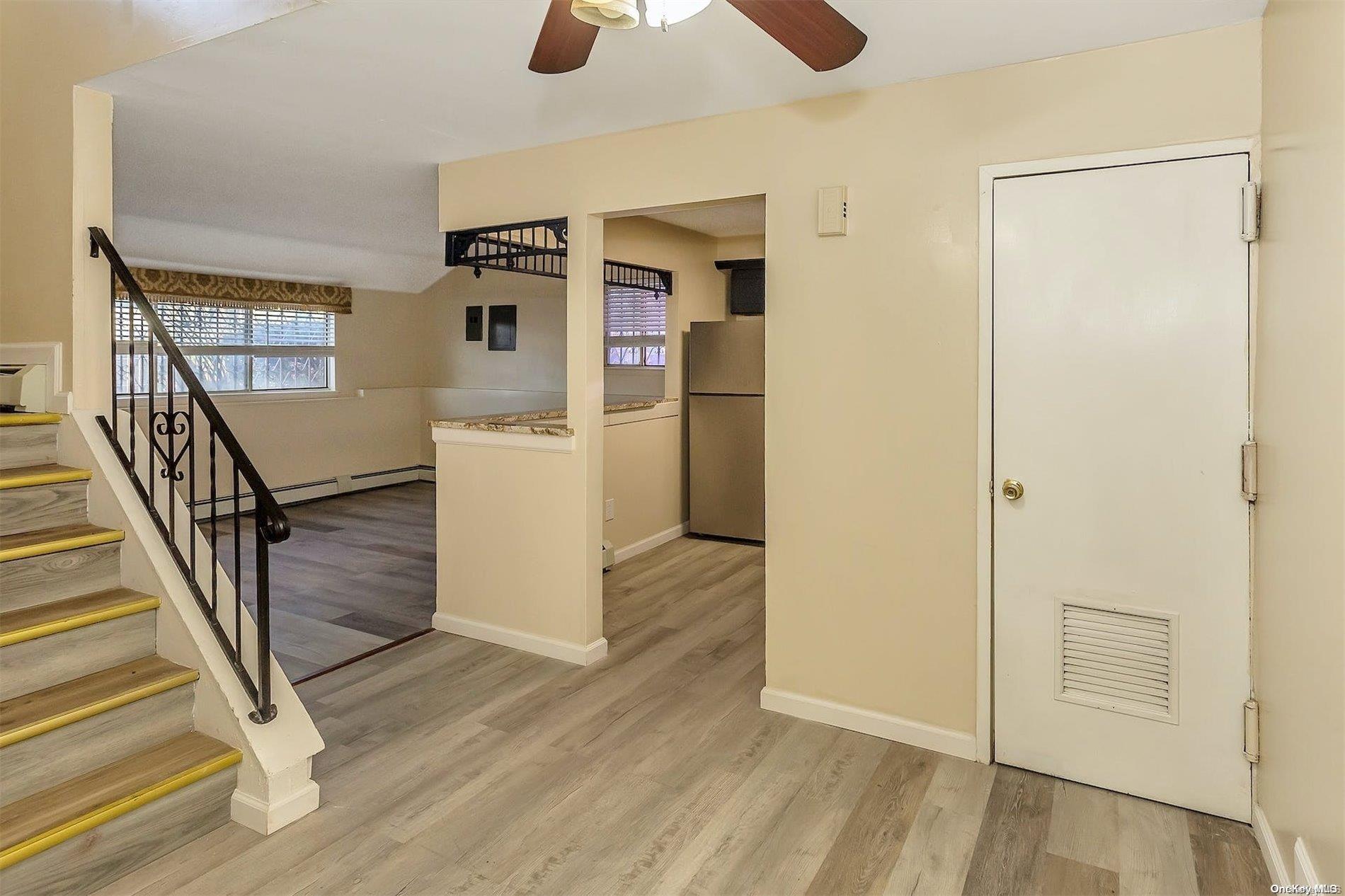 165-28 144th Drive Queens, NY 11434 - Photo 5 of 25 a view of a hallway with wooden floor and staircase