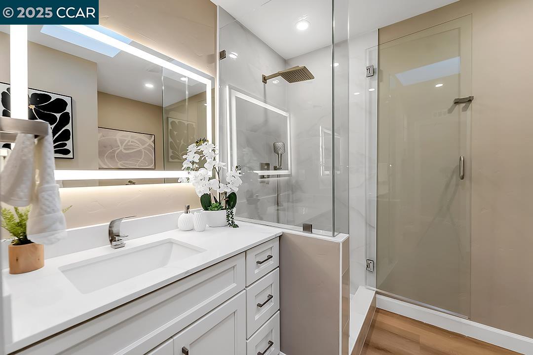1180 Running Springs Road, Unit 4 Walnut Creek, CA 94595 - Photo 12 of 24 a bathroom with a sink a mirror and a shower
