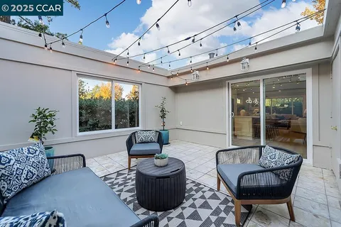 a living room with furniture and a floor to ceiling window