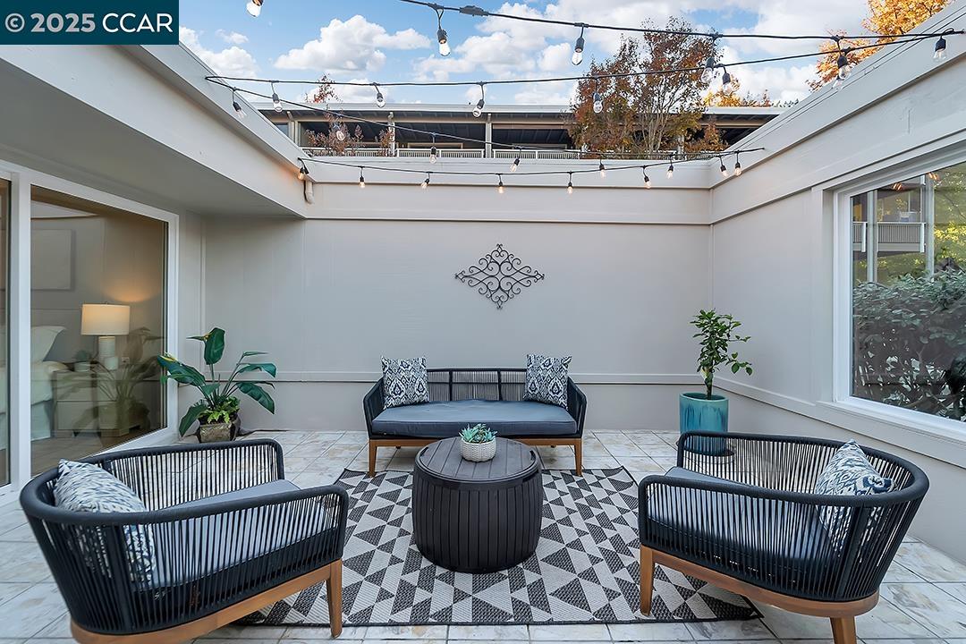 1180 Running Springs Road, Unit 4 Walnut Creek, CA 94595 - Photo 20 of 24 a living room with furniture and a chandelier