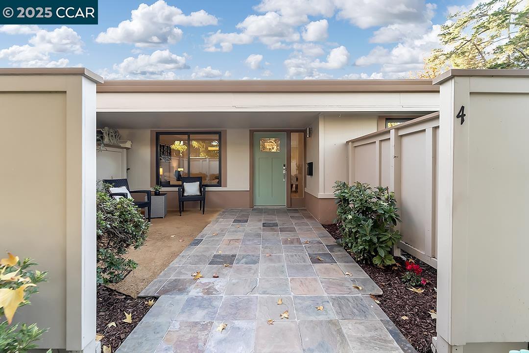 1180 Running Springs Road, Unit 4 Walnut Creek, CA 94595 - Photo 21 of 24 a view of a porch with dining table and chairs