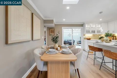 a dining room with furniture and wooden floor