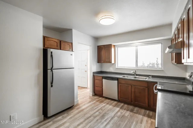 a view of a livingroom with wooden floor and stairs