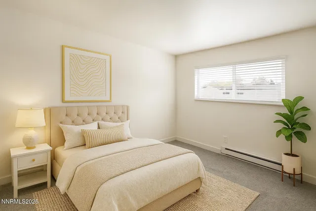 a bedroom with a bed and a potted plant