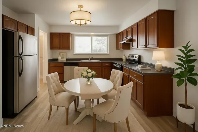 a kitchen with stainless steel appliances granite countertop a dining table chairs refrigerator and cabinets