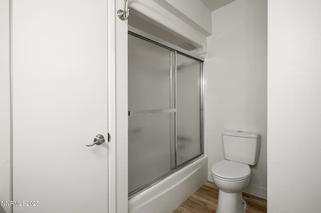 a bathroom with a toilet and a shower