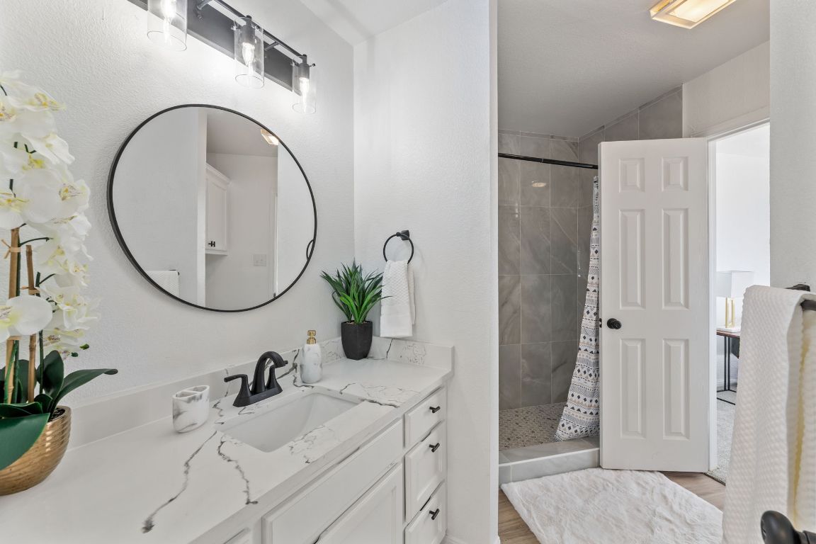 2127 Redwing Way Round Rock, TX 78664 - Photo 11 of 33 1st floor Bathroom with vanity, a shower stall, and light colored-style flooring