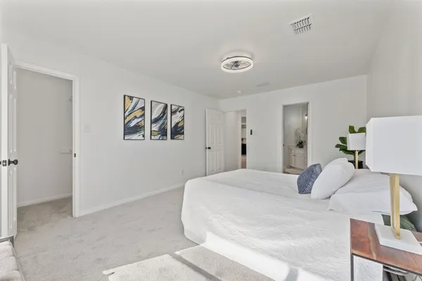a bedroom with a bed and a couch