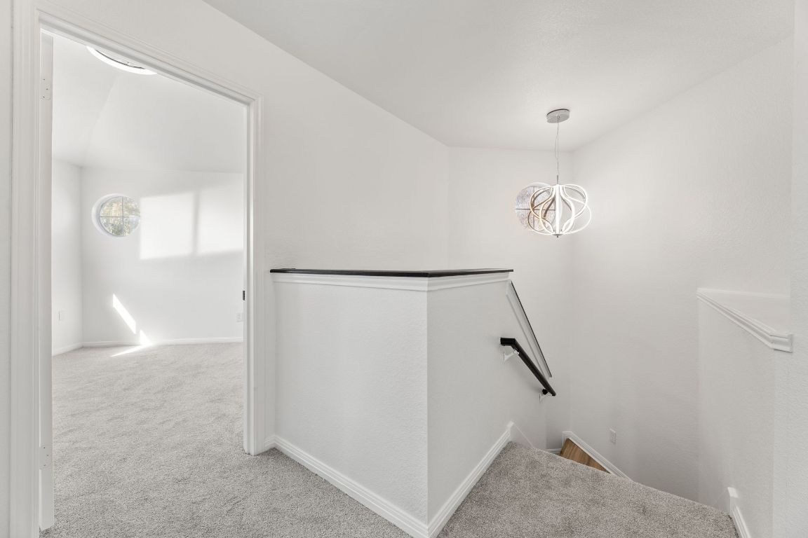 2127 Redwing Way Round Rock, TX 78664 - Photo 15 of 33 Staircase featuring carpet and a chandelier
