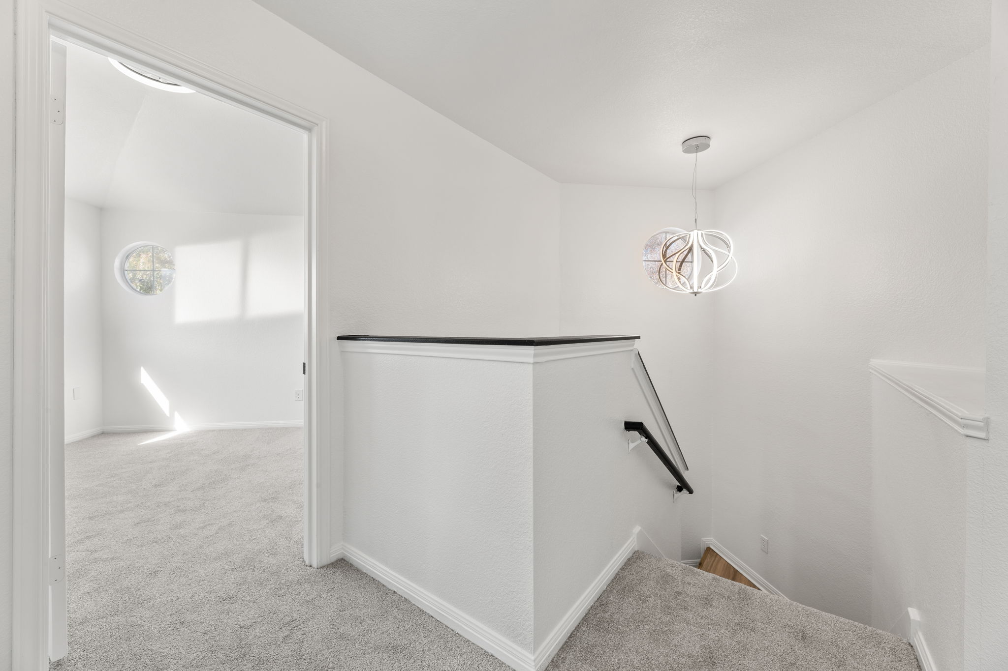 2127 Redwing Way Round Rock, TX 78664 - Photo 15 of 33 Staircase featuring carpet and a chandelier