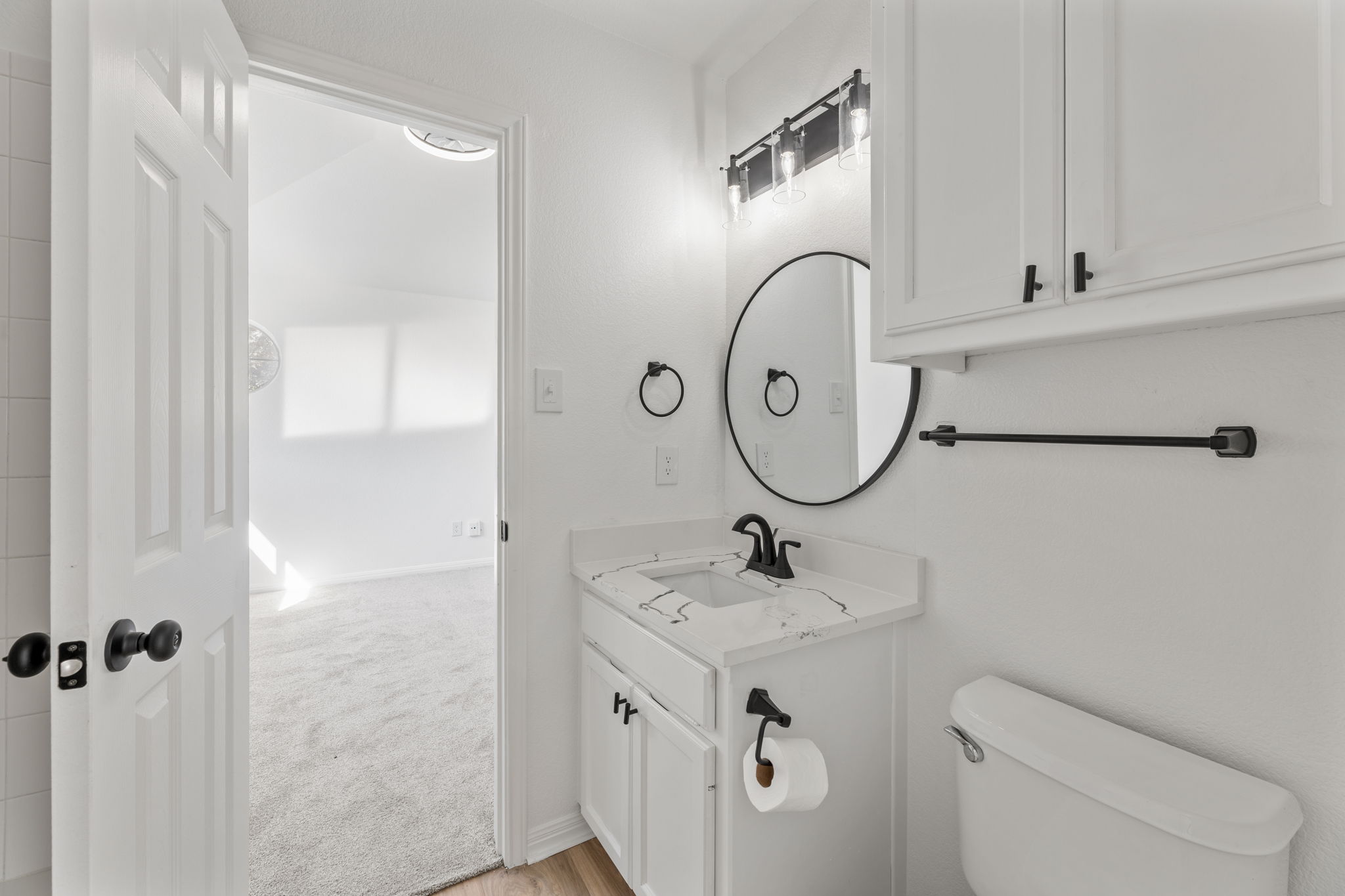 2127 Redwing Way Round Rock, TX 78664 - Photo 19 of 33 a bathroom with a sink a toilet and a mirror