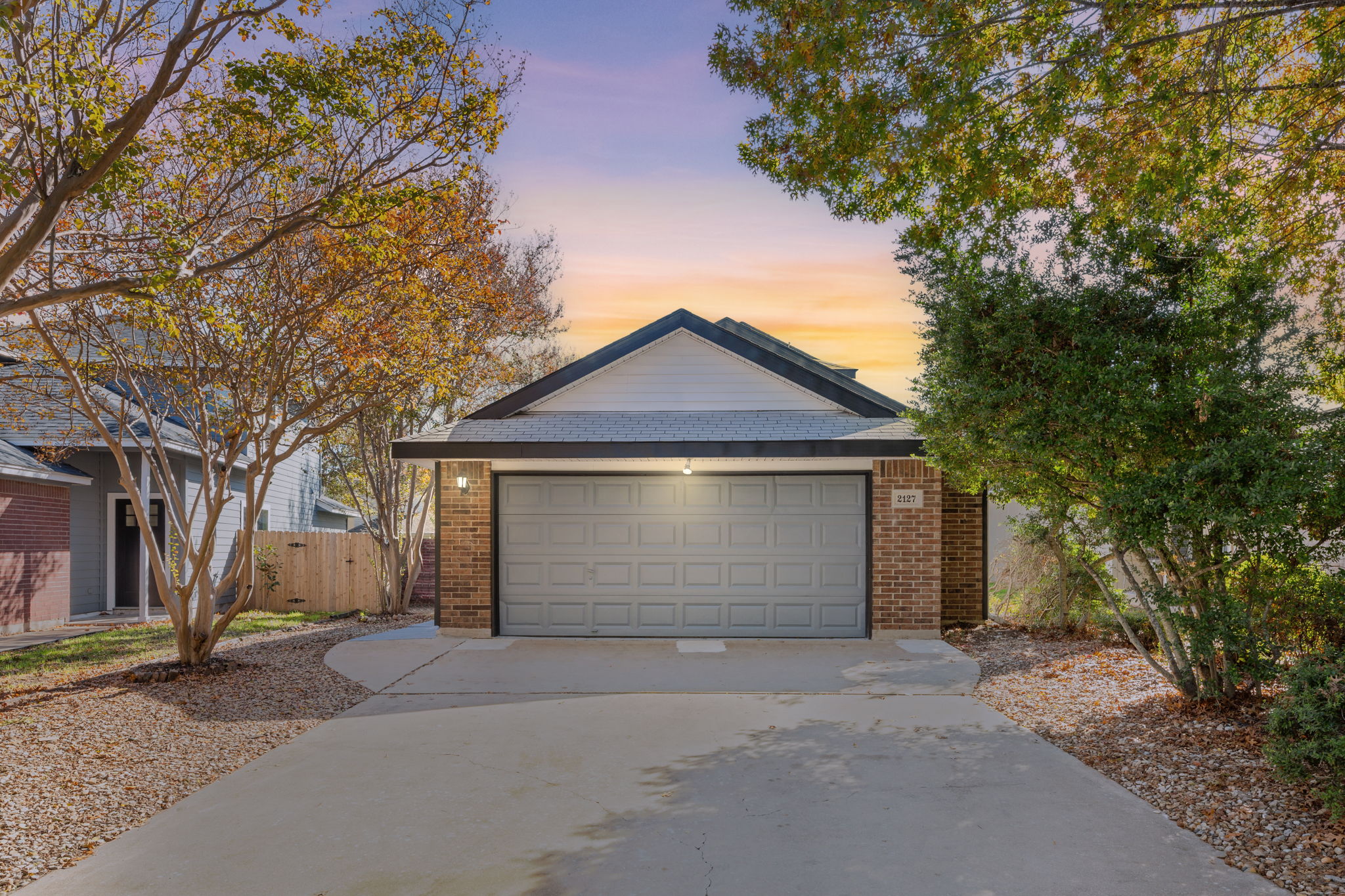 2127 Redwing Way Round Rock, TX 78664 - Photo 2 of 33 View of front of house with concrete driveway, brick siding, and a garage