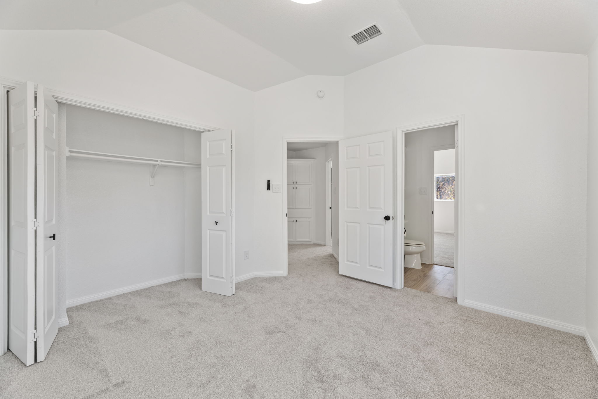 2127 Redwing Way Round Rock, TX 78664 - Photo 21 of 33 Third bedroom with vaulted ceiling, light carpet, and a closet