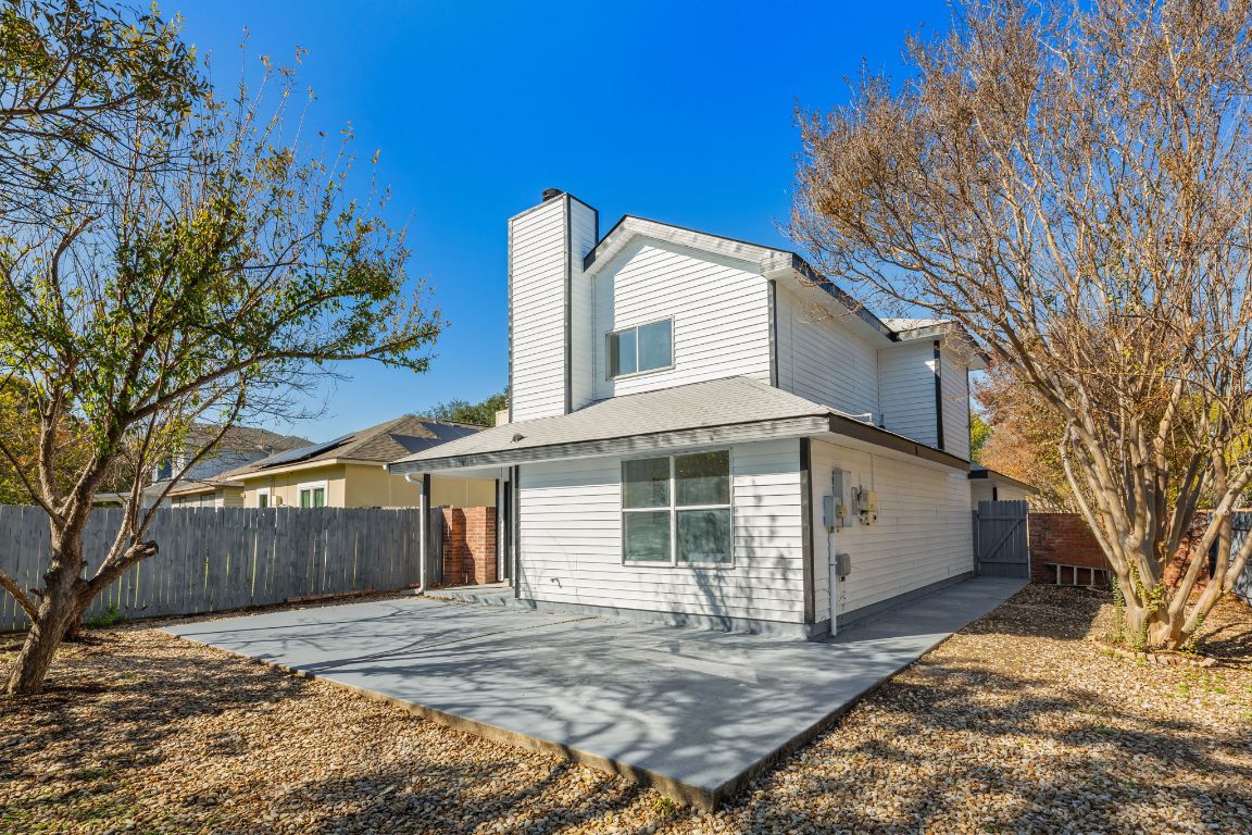 2127 Redwing Way Round Rock, TX 78664 - Photo 27 of 33 View of front of home with a fenced backyard, a chimney, a patio area.