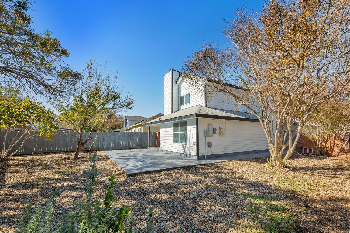 2127 Redwing Way Round Rock, TX 78664 - Photo 28 of 33 Back of house with a fenced backyard, a chimney, and a patio