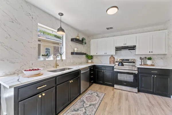 a kitchen with a sink stove and cabinets