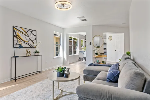 a living room with furniture and wooden floor