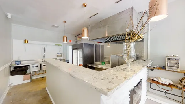a kitchen with stainless steel appliances kitchen island granite countertop a sink and cabinets