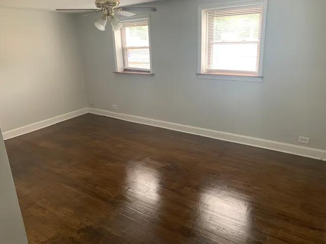 a view of an empty room with a fan