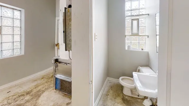 a bathroom with a toilet and a shower