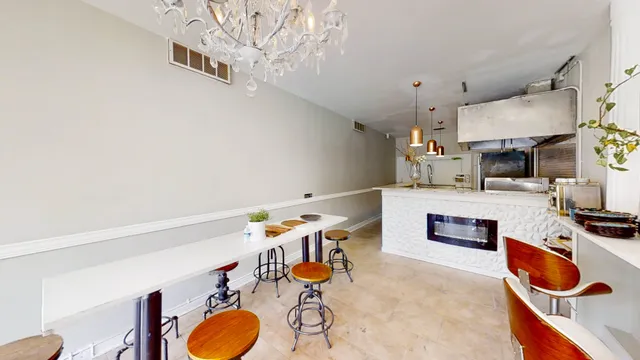 a room with furniture and a kitchen view