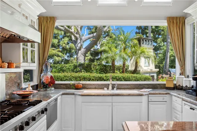 a kitchen with a large window and sink