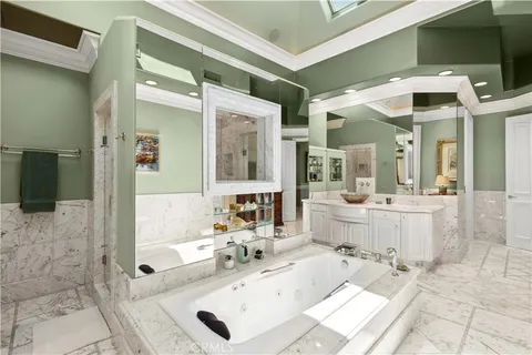 a bathroom with a tub sink and mirror