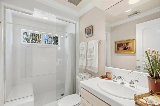 a bathroom with a sink mirror and toilet