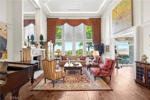 a living room with fireplace furniture and a large window