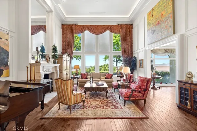 a living room with fireplace furniture and a large window