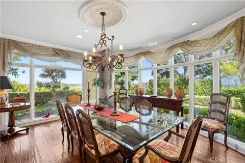 a view of a dining room with furniture wooden floor and chandelier