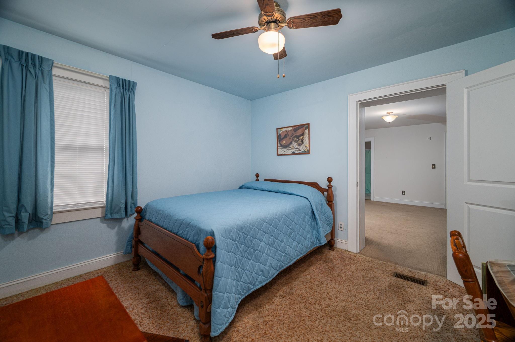 1544 Kings Road Shelby, NC 28150 - Photo 15 of 25 a bedroom with a bed and a chandelier