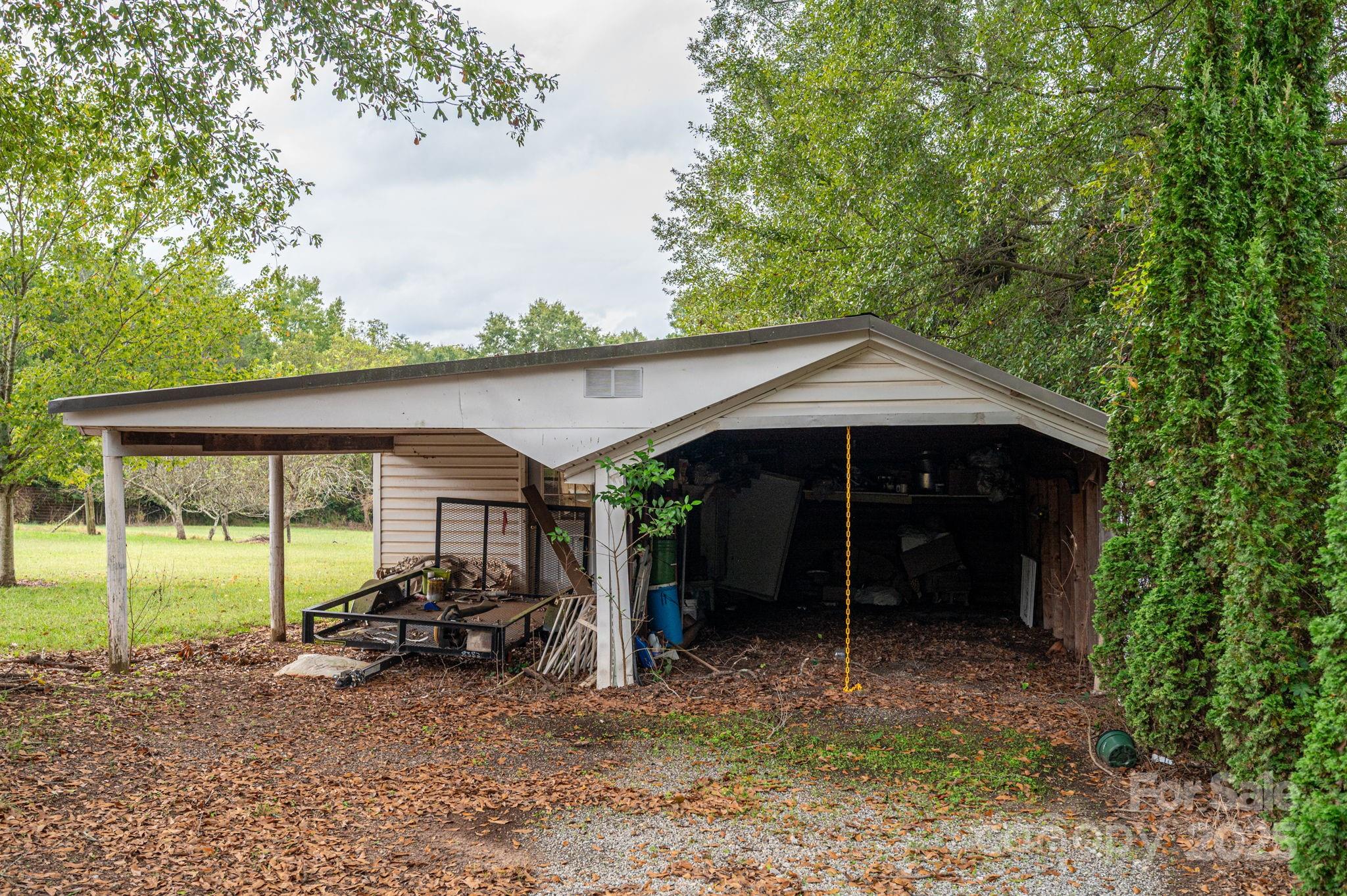 1544 Kings Road Shelby, NC 28150 - Photo 10 of 25 a view of a patio with a table and chairs under an umbrella
