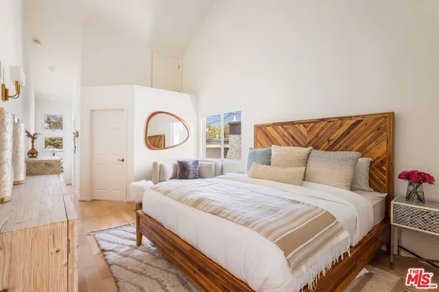 a bedroom with a bed and a potted plant