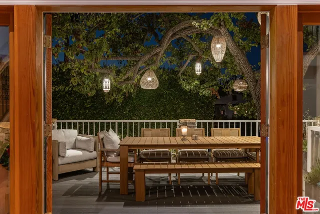 a balcony with a table and chairs