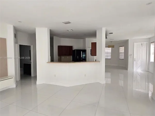 a view of a big room with kitchen and windows