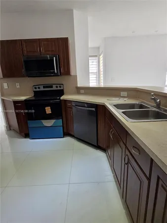 a kitchen with a sink and a stove top oven