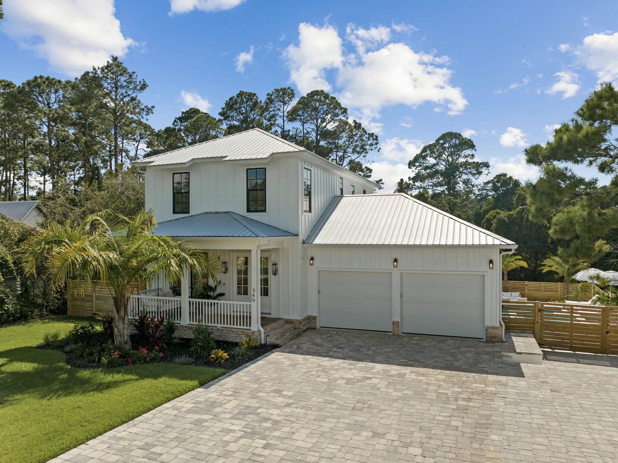 349 Seabreeze Blvd Inlet Beach Inlet Beach, FL 32461 - Photo 18 of 74 a view of a white house with a yard and table and chairs under an umbrella