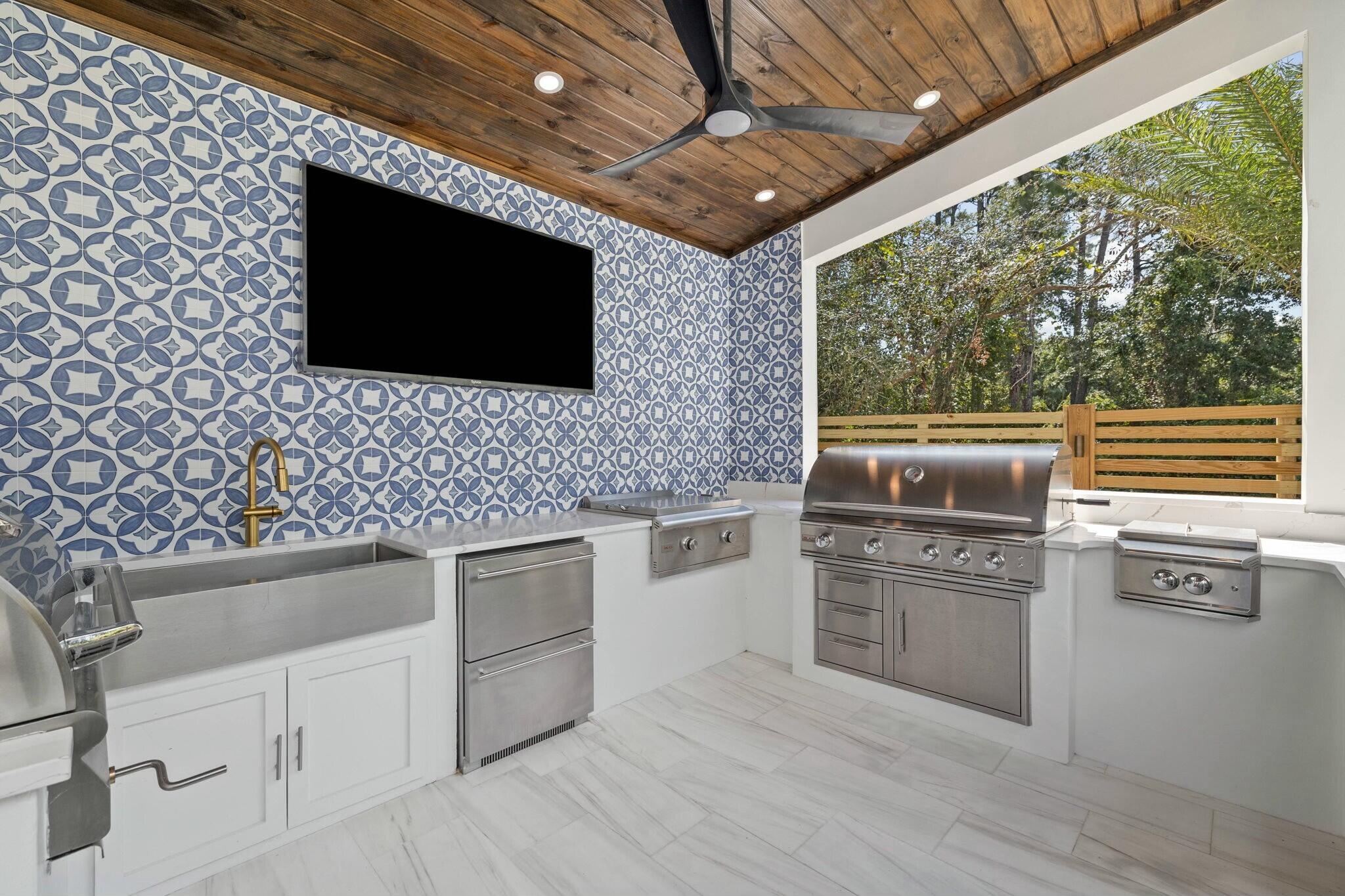 349 Seabreeze Blvd Inlet Beach Inlet Beach, FL 32461 - Photo 29 of 74 a kitchen with stainless steel appliances a stove a microwave and white cabinets