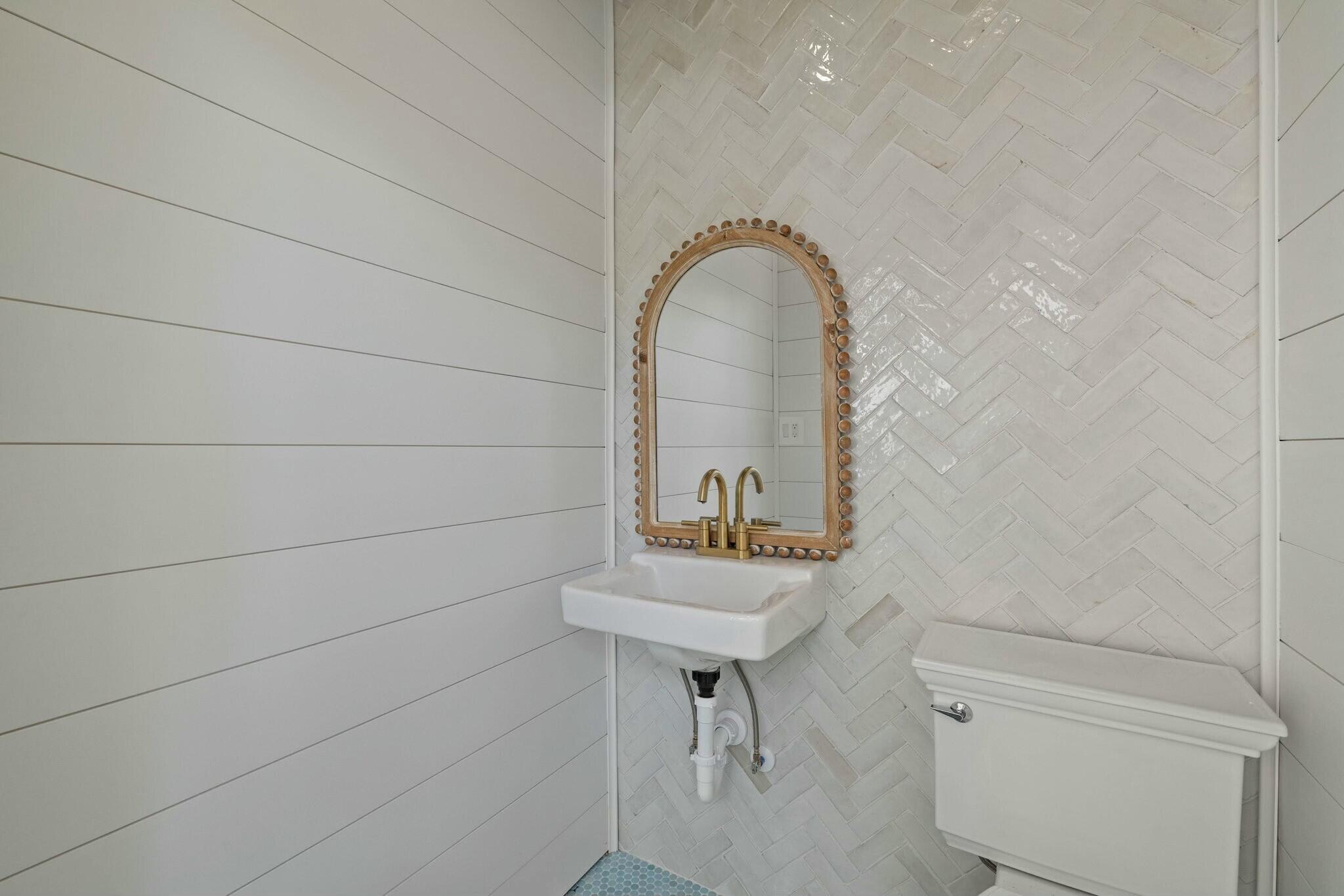 349 Seabreeze Blvd Inlet Beach Inlet Beach, FL 32461 - Photo 31 of 74 a bathroom with a sink a toilet and a mirror