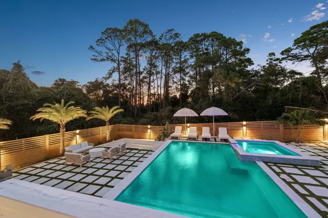 an aerial view of a house with swimming pool patio and outdoor seating