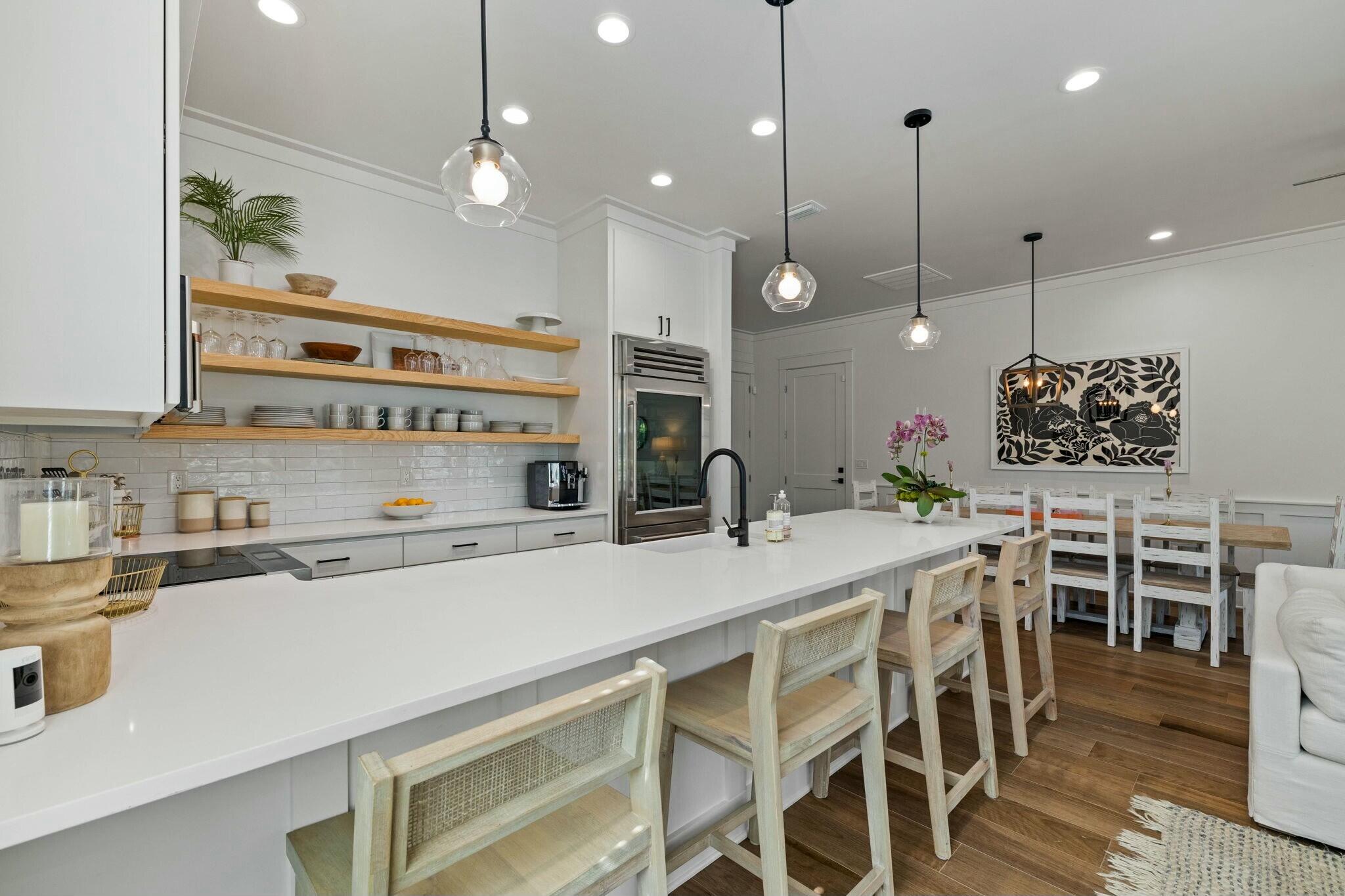 349 Seabreeze Blvd Inlet Beach Inlet Beach, FL 32461 - Photo 44 of 74 a kitchen with kitchen island a table and chairs in it