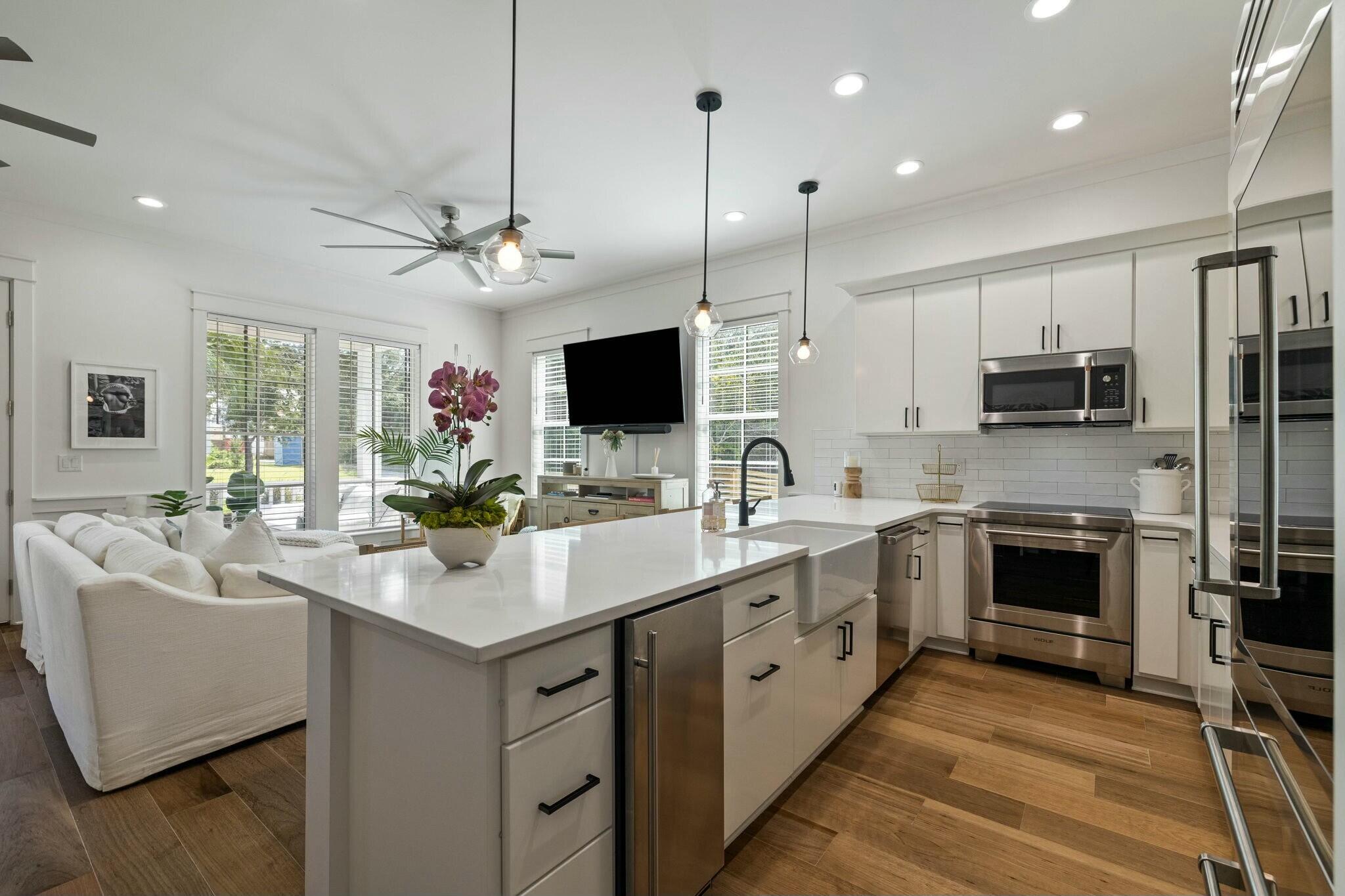 349 Seabreeze Blvd Inlet Beach Inlet Beach, FL 32461 - Photo 45 of 74 a kitchen with stainless steel appliances kitchen island granite countertop a sink and a refrigerator