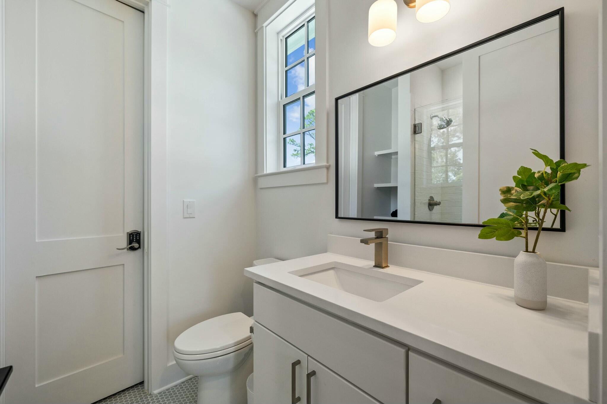 349 Seabreeze Blvd Inlet Beach Inlet Beach, FL 32461 - Photo 63 of 74 a bathroom with a sink a toilet and a mirror