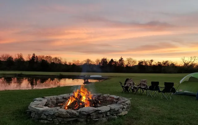 a view of a house with a big yard and large trees