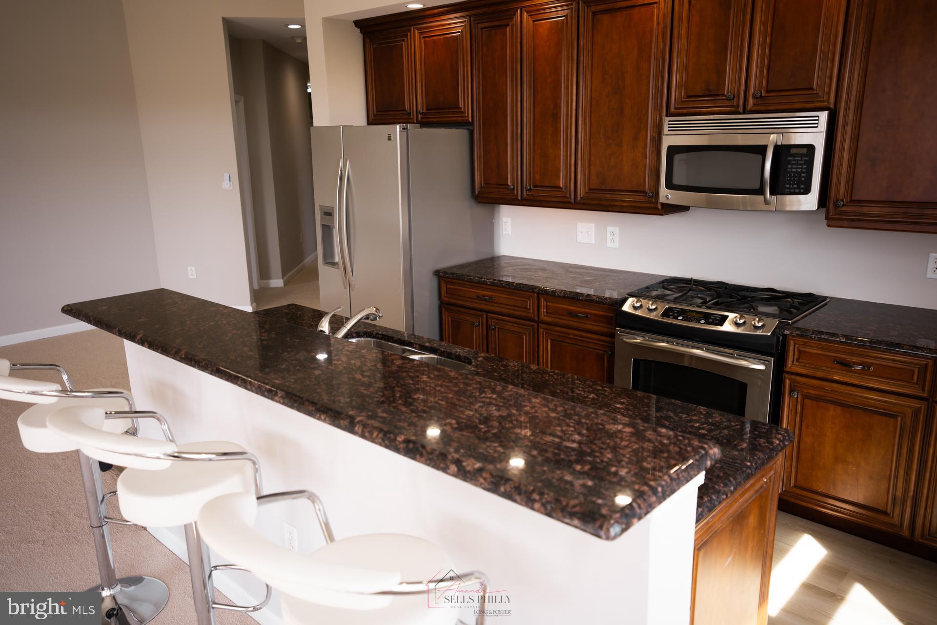 528 Carson Terrace Huntingdon Valley, PA 19006 - Photo 11 of 43 a kitchen with a stove and a microwave