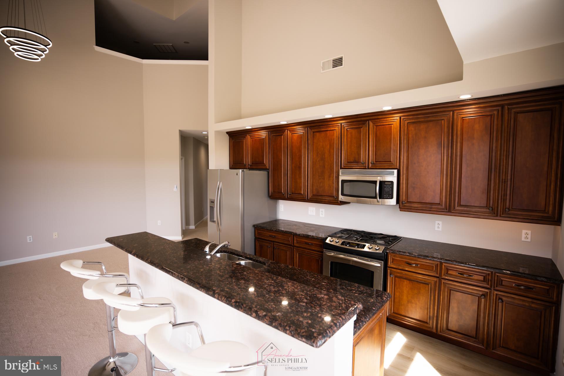 528 Carson Terrace Huntingdon Valley, PA 19006 - Photo 12 of 43 a kitchen with stainless steel appliances a stove a sink and white cabinets