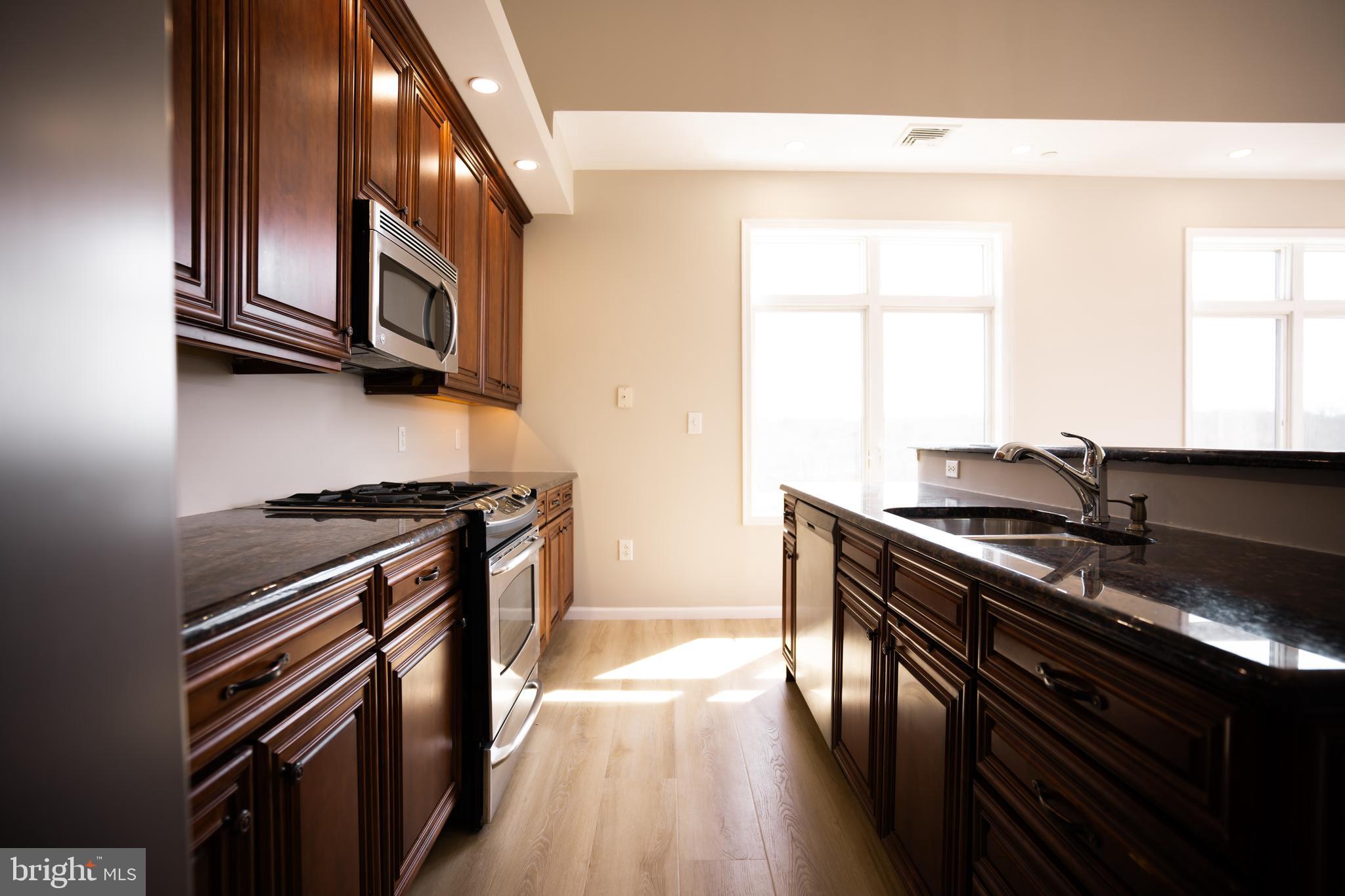 528 Carson Terrace Huntingdon Valley, PA 19006 - Photo 15 of 43 a kitchen with stainless steel appliances a stove a sink and a microwave