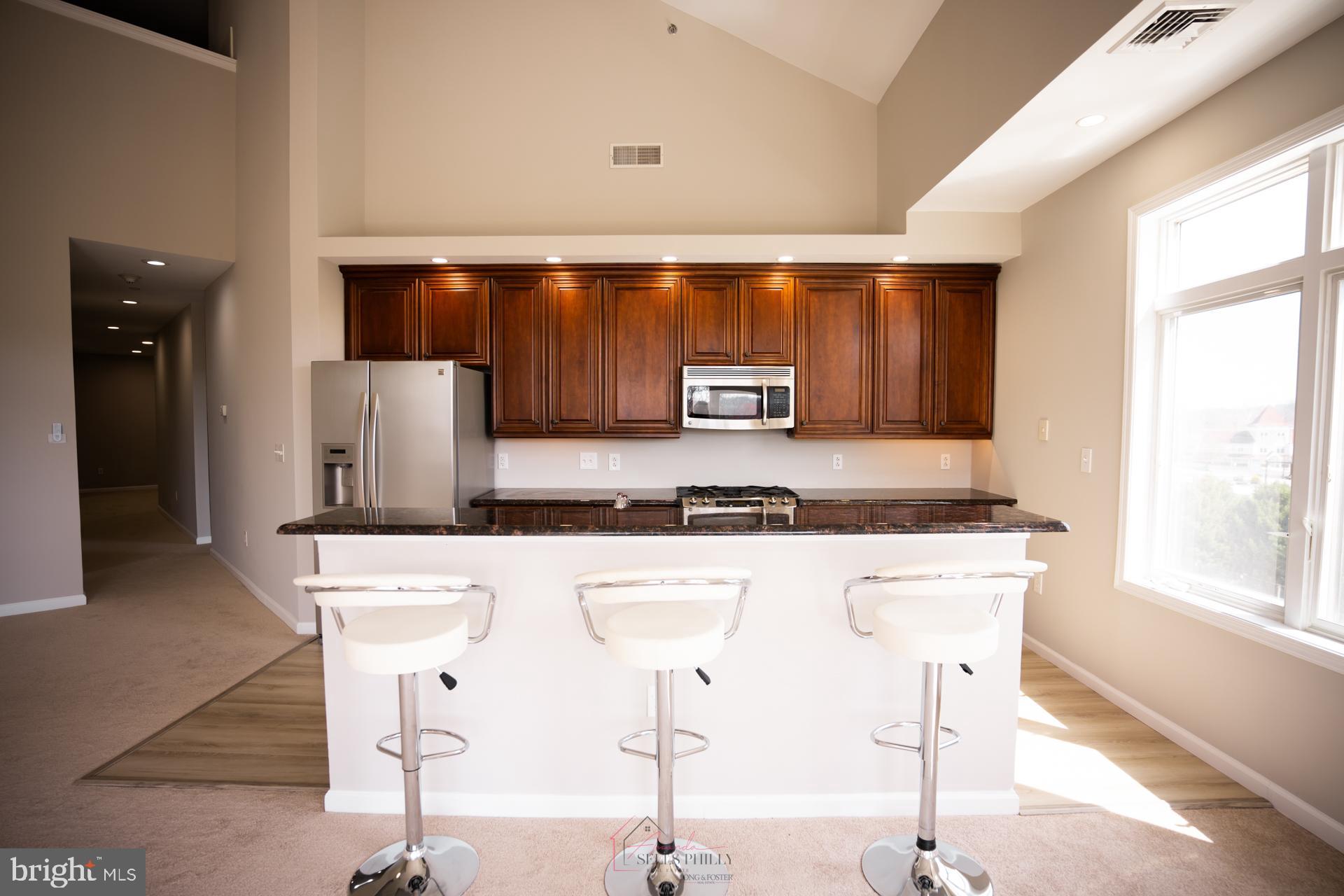 528 Carson Terrace Huntingdon Valley, PA 19006 - Photo 6 of 43 a kitchen with stainless steel appliances granite countertop a sink and a refrigerator