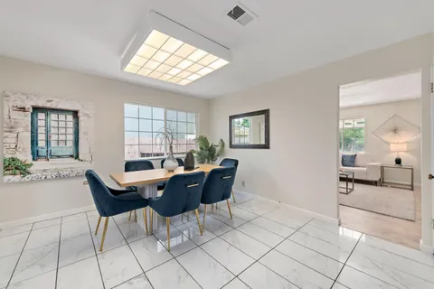a dining room with furniture and window